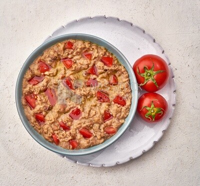 Close-up of oriental breakfast, a dish of foul medames with tomato, Arabic breakfast, arab restaurant
