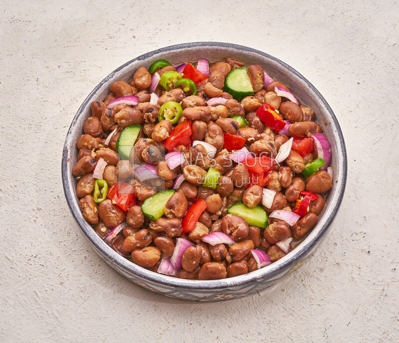 Close-up of oriental breakfast, a dish of foul medames with vegetables, Arabic breakfast, arab restaurant