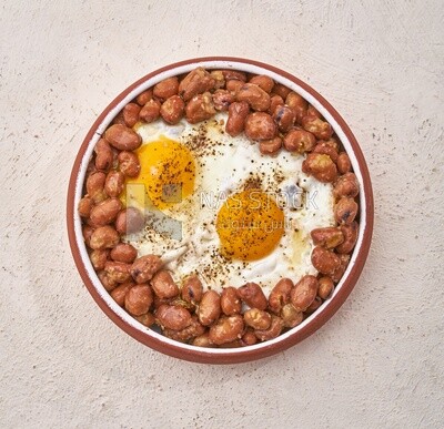 Close-up of oriental breakfast, a dish of foul medames with fried egg, Arabic breakfast, arab restaurant