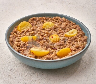 Close-up of oriental breakfast, a dish of foul medames with lemon slices, Arabic breakfast, arab restaurant