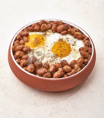 Close-up of oriental breakfast, a dish of foul medames with fried egg, Arabic breakfast, arab restaurant