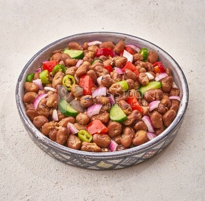 Close-up of oriental breakfast, a dish of foul medames with vegetables, Arabic breakfast, arab restaurant