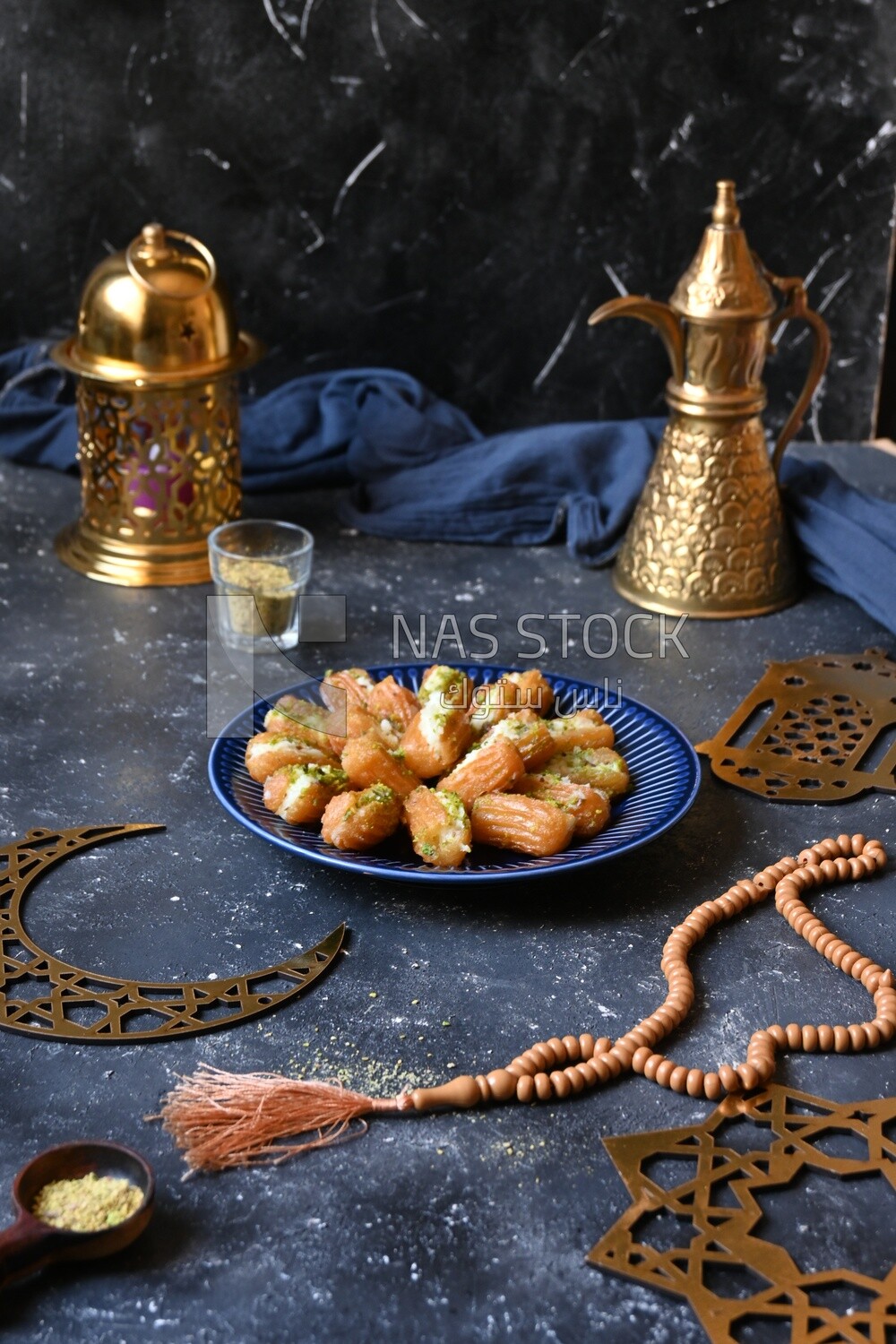 Tulumba with cream in it beside nuts, eastern sweets, Arabic Restaurant