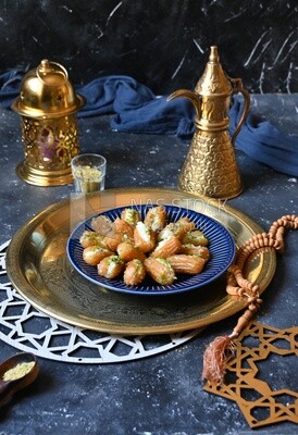 Tulumba with cream in it beside nuts, eastern sweets, Arabic Restaurant