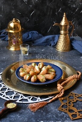 Tulumba with cream in it beside nuts, eastern sweets, Arabic Restaurant