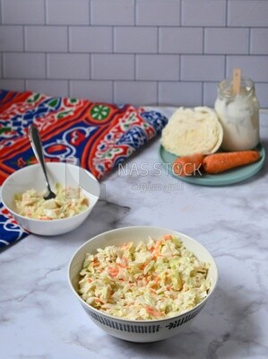 Bowl of Coleslaw beside the ingredients​ of it, cold appetizers, Arabic dishes, oriental foods