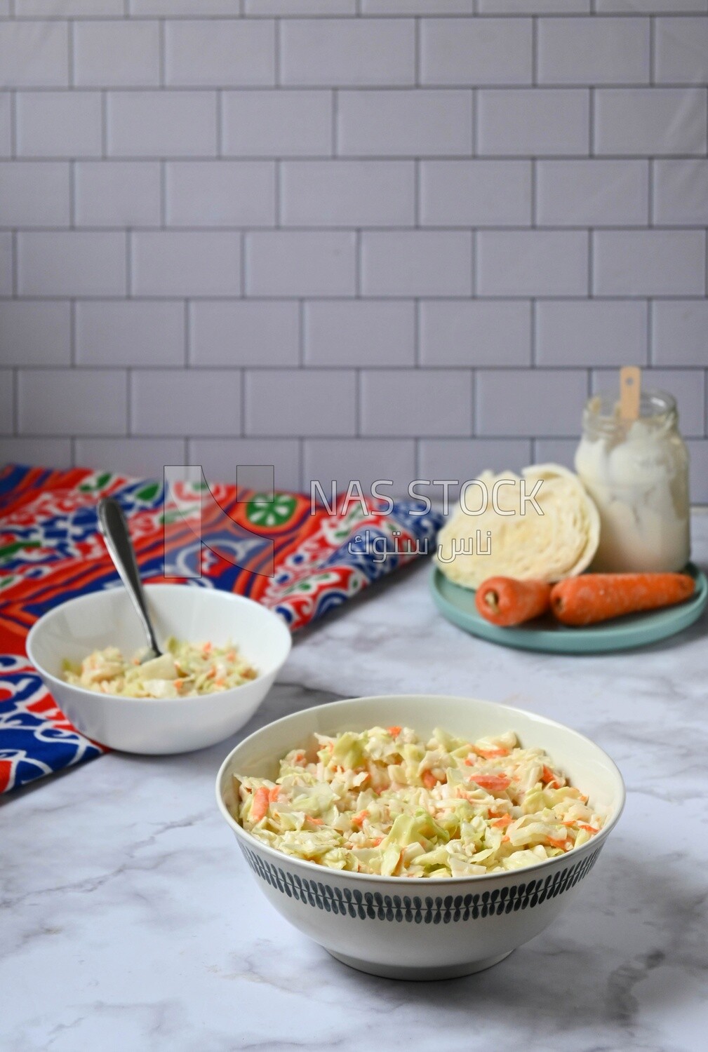 Bowl of Coleslaw beside the ingredients​ of it, cold appetizers, Arabic dishes, oriental foods