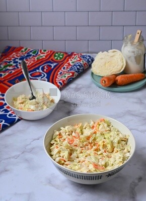 Bowl of Coleslaw beside the ingredients​ of it, cold appetizers, Arabic dishes, oriental foods