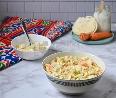 Bowl of Coleslaw beside the ingredients​ of it, cold appetizers, Arabic dishes, oriental foods