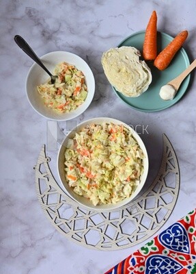 Bowl of Coleslaw beside the ingredients​ of it, cold appetizers, Arabic dishes, oriental foods