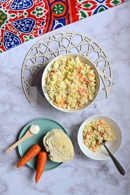 Bowl of Coleslaw beside the ingredients​ of it, cold appetizers, Arabic dishes, oriental foods