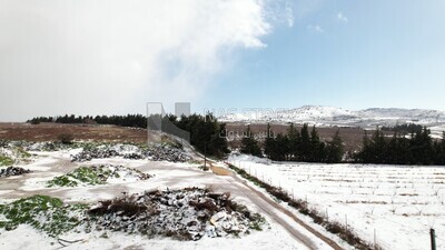 Drone footage of the Majdal Shams village on a snowy day, landscape waterfall, tourism in Palestine