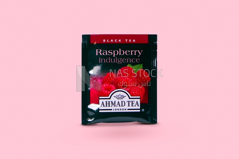 Pack of tea with raspberry flavor, delicious hot drink, hot drinks