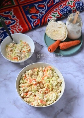 Bowl of Coleslaw beside the ingredients​ of it, cold appetizers, Arabic dishes, oriental foods