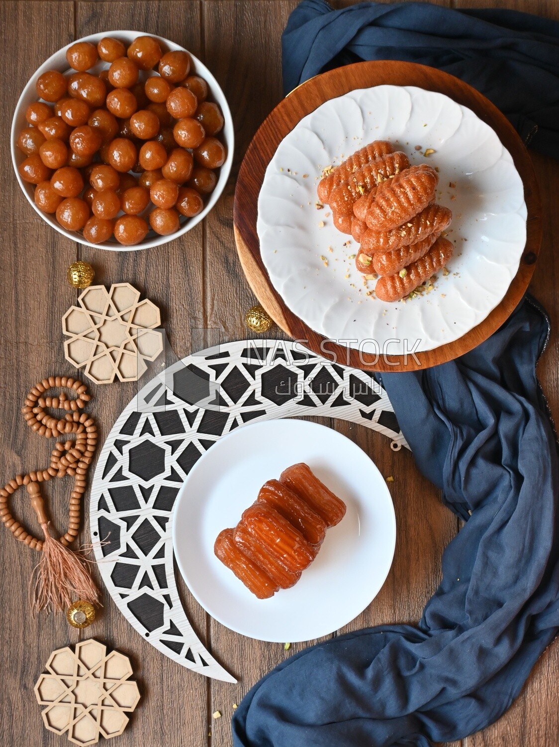 group of oriental sweets in a Ramadan atmosphere , Zalabia , Balah El Sham ​