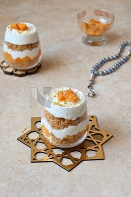 Two cups of kunafa with mango and cream, Ramadan sweets