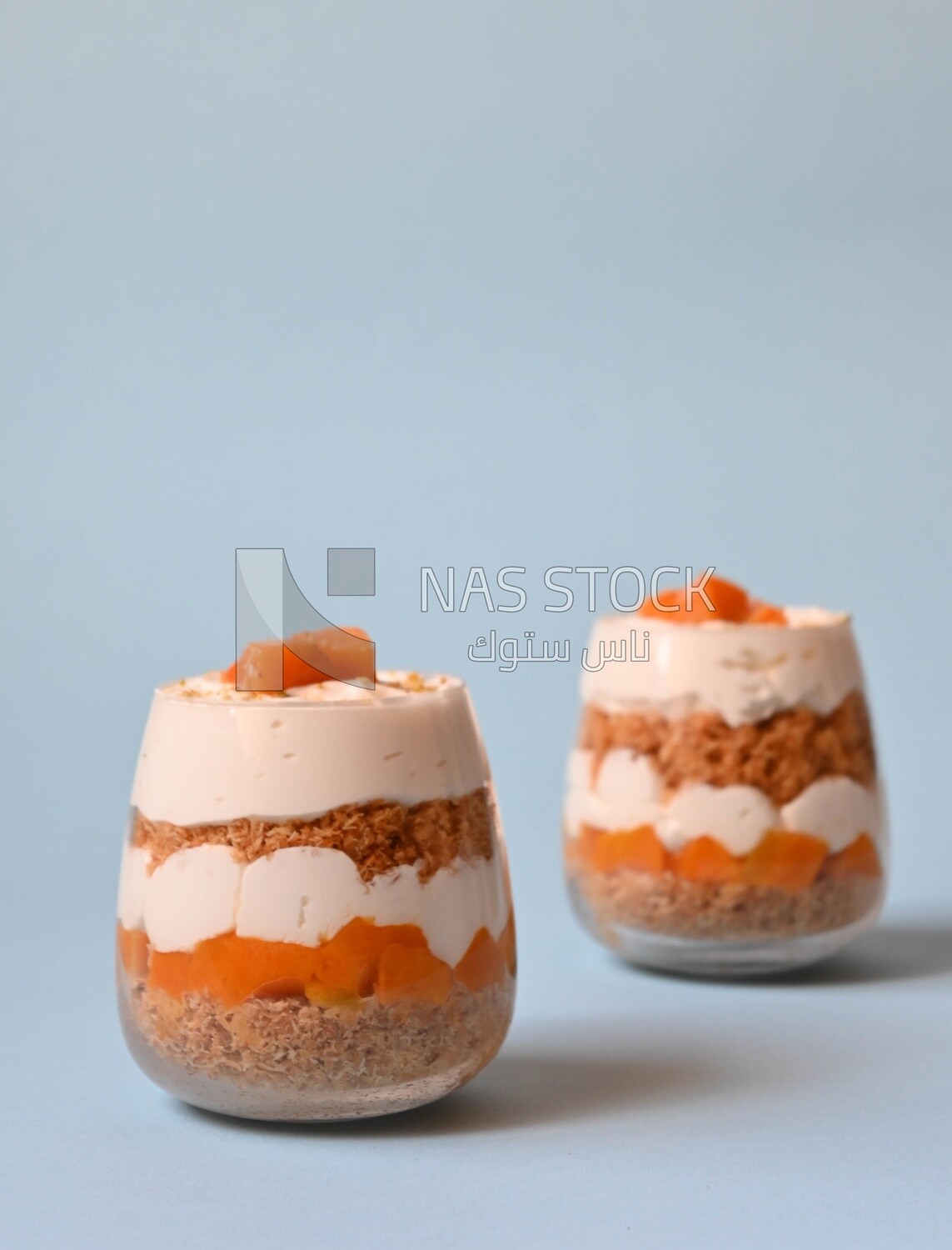 Two cups of kunafa with mango and cream, Ramadan sweets