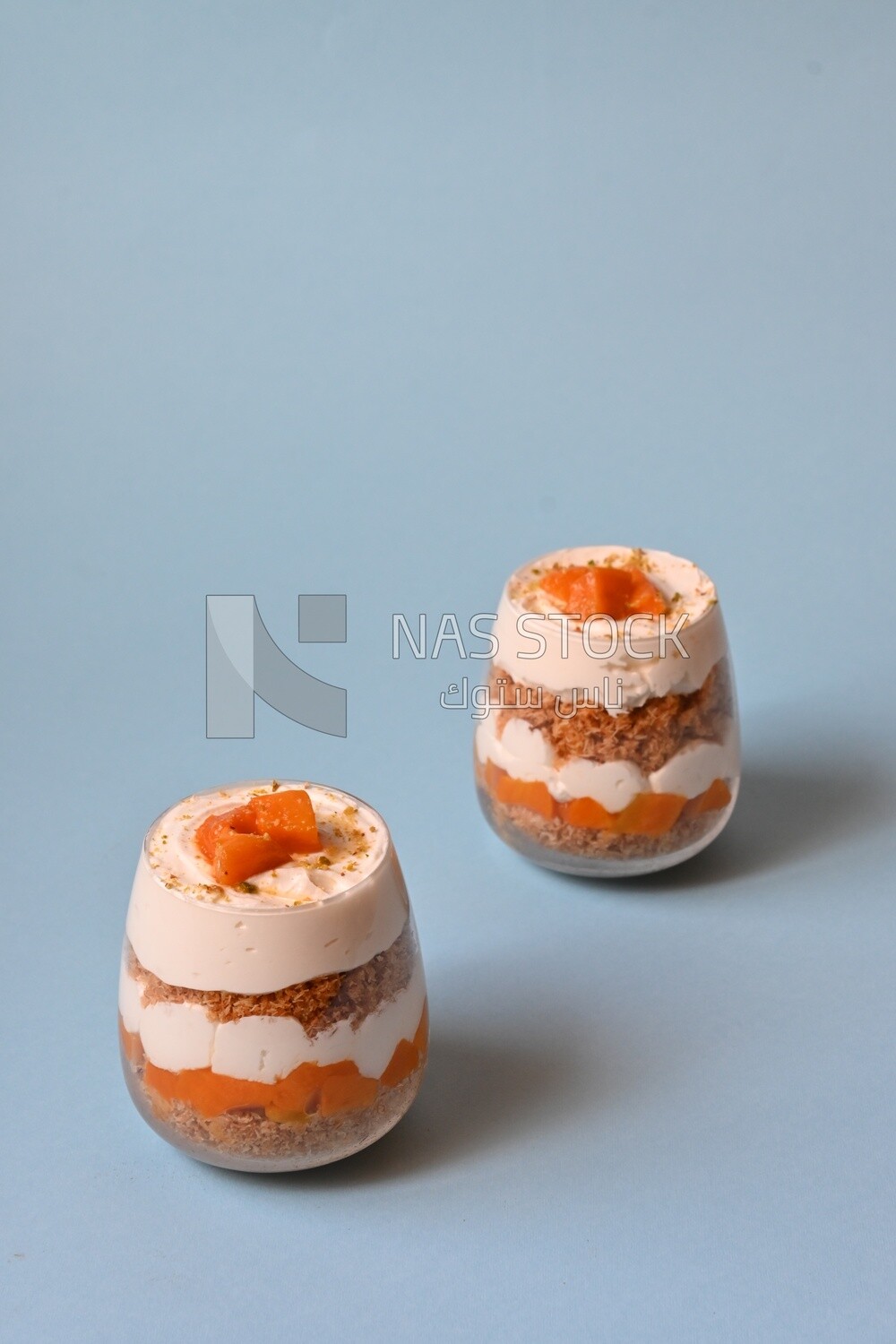 Two cups of kunafa with mango and cream, Ramadan sweets