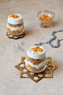 Two cups of kunafa with mango and cream, Ramadan sweets