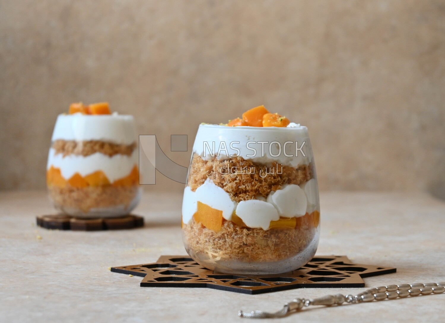 Two cups of kunafa with mango and cream, Ramadan sweets