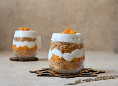 Two cups of kunafa with mango and cream, Ramadan sweets