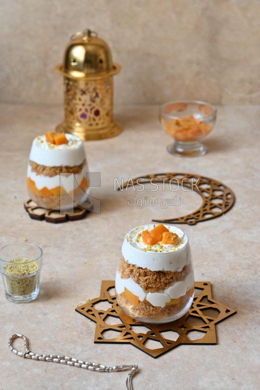 Two cups of kunafa with mango and cream, Ramadan sweets