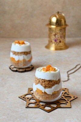 Two cups of kunafa with mango and cream, Ramadan sweets