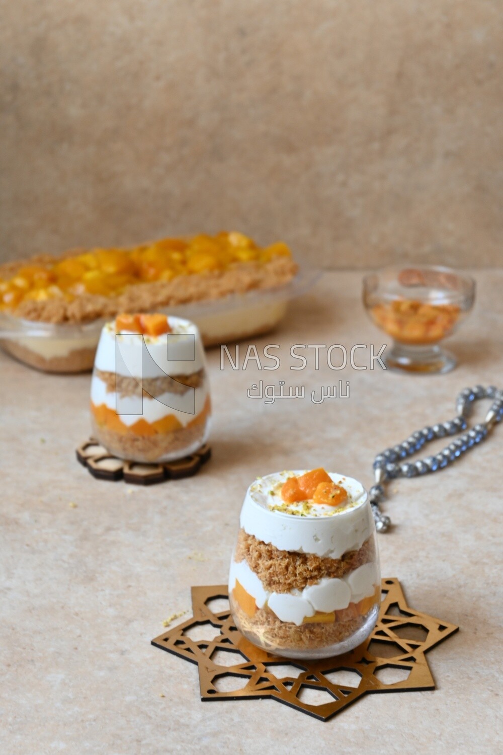 Two cups of kunafa with mango and cream, Ramadan sweets