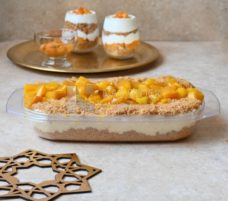 Tray of kunafa with mango and cream, Ramadan sweets