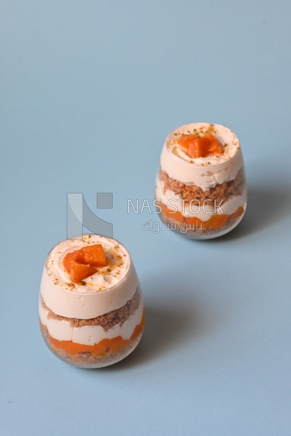 Two cups of kunafa with mango and cream, Ramadan sweets