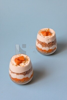 Two cups of kunafa with mango and cream, Ramadan sweets