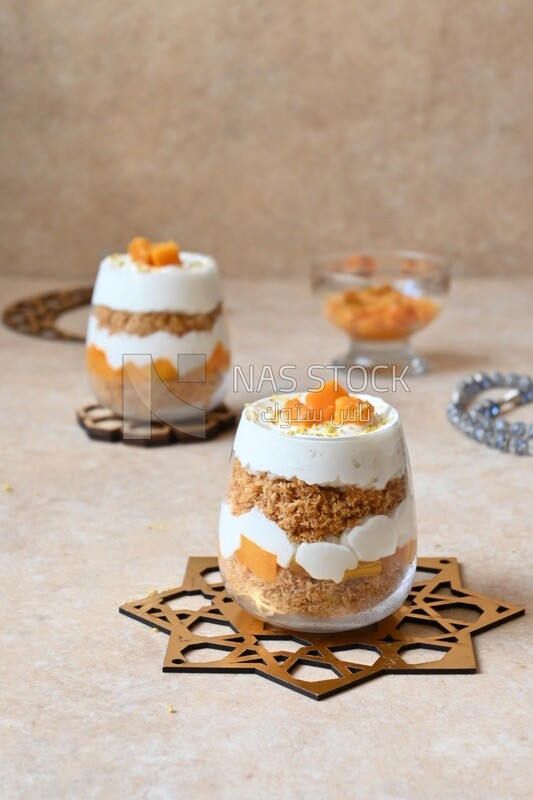 Two cups of kunafa with mango and cream, Ramadan sweets