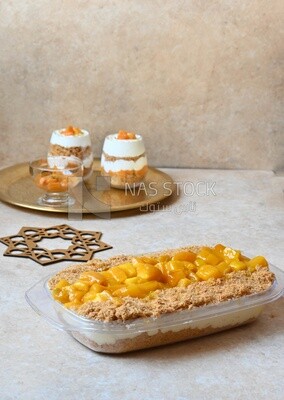 Tray of kunafa with mango and cream, Ramadan sweets