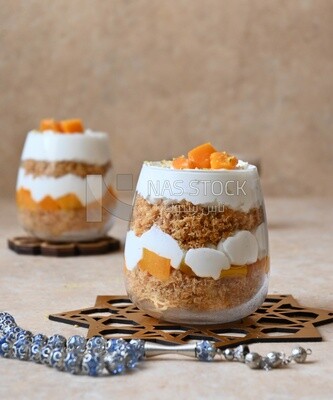 Two cups of kunafa with mango and cream, Ramadan sweets
