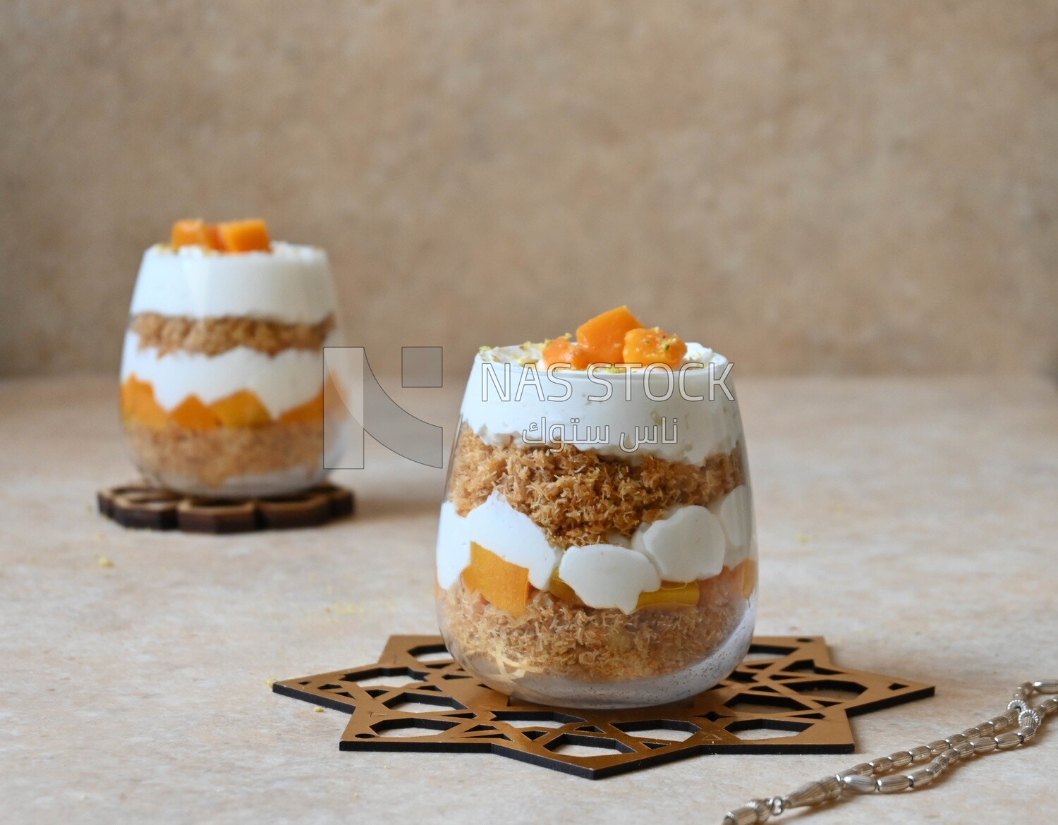Two cups of kunafa with mango and cream, Ramadan sweets