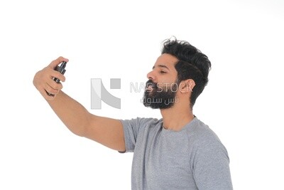 Saudi man holding a perfume bottle