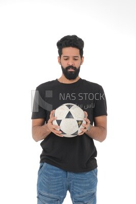 Saudi man holding a ball, playing football,  practicing soccer sports, playing with the ball, white background, Saudi model