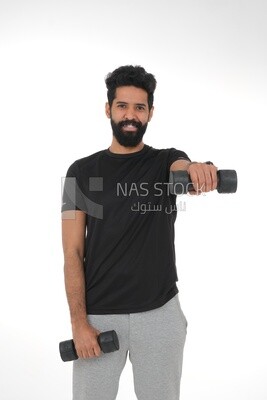 Saudi man Wearing sports clothes, exercising with dumbbells, bodybuilding, healthy lifestyle, building muscle, white background, Saudi model