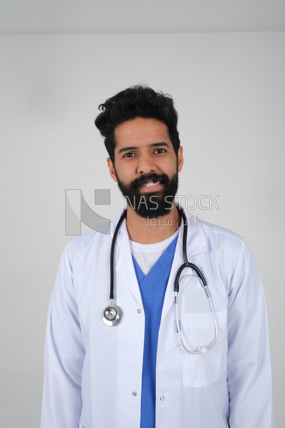 Saudi man wearing a medical coat and a stethoscope, white background, medicine and health care, Saudi model