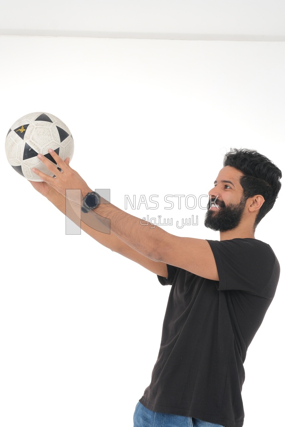 Saudi man holding a ball, playing football,  practicing soccer sports, playing with the ball, white background, Saudi model