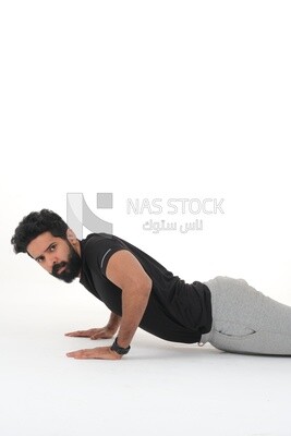 Saudi man doing warm-up exercises, push-ups, bodybuilding, healthy lifestyle, building muscle, white background, Saudi model
