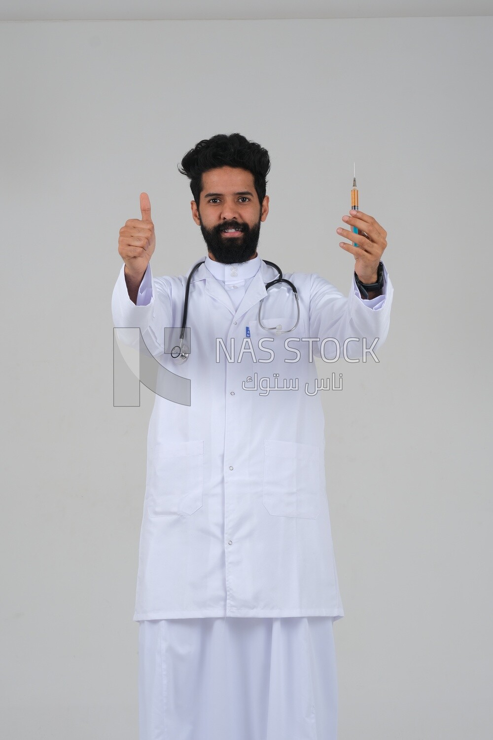 Saudi man wearing a medical coat and a stethoscope, holding a medical needle, white background, medicine and health care, Saudi model
