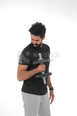 Saudi man Wearing sports clothes, exercising with dumbbells, bodybuilding, healthy lifestyle, building muscle, white background, Saudi model