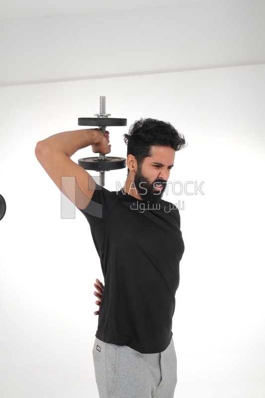 Saudi man Wearing sports clothes, exercising with dumbbells, bodybuilding, healthy lifestyle, building muscle, white background, Saudi model