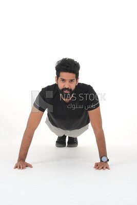 Saudi man doing warm-up exercises, push-ups, bodybuilding, healthy lifestyle, building muscle, white background, Saudi model