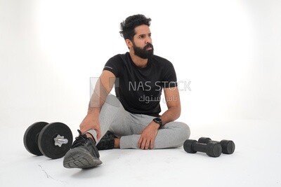 Saudi man doing warm-up exercises, push-ups, bodybuilding, healthy lifestyle, building muscle, white background, Saudi model