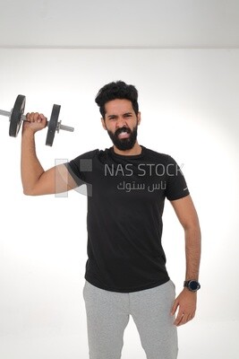 Saudi man Wearing sports clothes, exercising with dumbbells, bodybuilding, healthy lifestyle, building muscle, white background, Saudi model