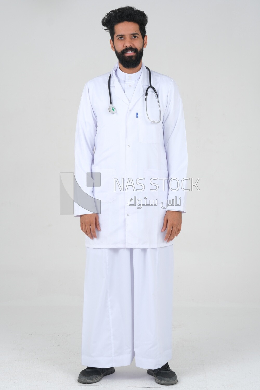 Saudi man wearing a medical coat and a stethoscope, white background, medicine and health care, Saudi model