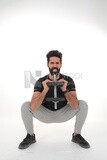 Saudi man Wearing sports clothes, exercising with dumbbells, bodybuilding, healthy lifestyle, building muscle, white background, Saudi model