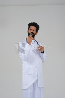 Saudi man wearing a medical coat and a stethoscope, holding a medical needle, white background, medicine and health care, Saudi model